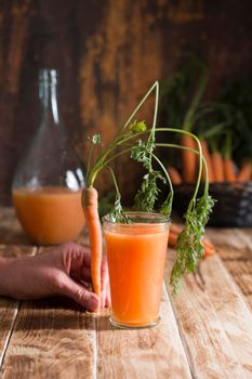 freshly squeezed carrot juice, and raw carrots, vegetarian vegetable vitamin drink, vintage still life concept, fresh carrot juice on wooden background, rustic still life