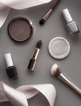 Beauty, make-up and cosmetics flatlay design with copyspace, cosmetic products and makeup tools on gray background, girly and feminine style concept