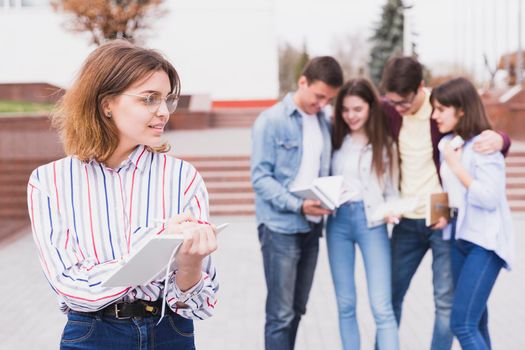 woman glasses standing holding notebook hands