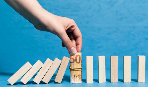 woman holding bank notes fallen pieces wood