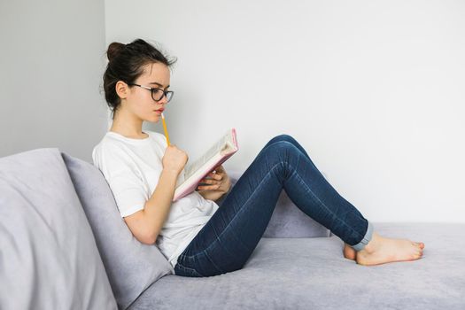 barefoot woman reading thinking