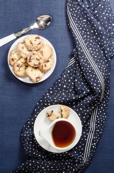 Porcelain dishes and cookies with cranberries. From series Playing with Color