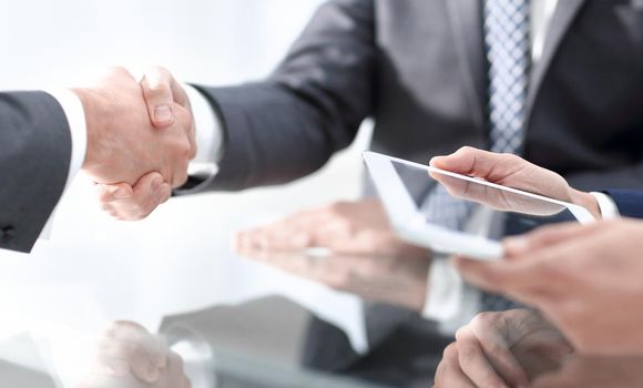 handshake business colleagues in office