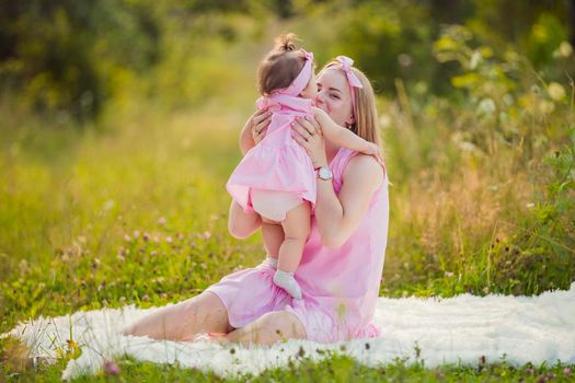 child in the arms of a mother who is in nature