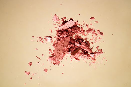 Crushed cosmetics, mineral organic eyeshadow, blush and cosmetic powder isolated on golden background, makeup and beauty banner, flatlay design.