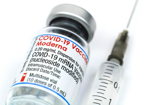 Madrid, Spain- August 6, 2021: Syringe and vial with Moderna covid-19 vaccine on white background