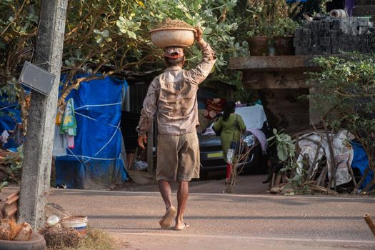 Man Balancing Bowl on Head, India