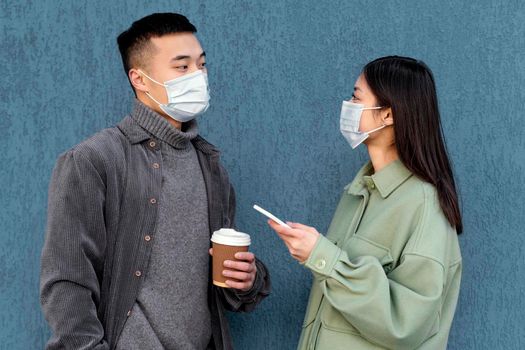 young japanese couple wearing mask