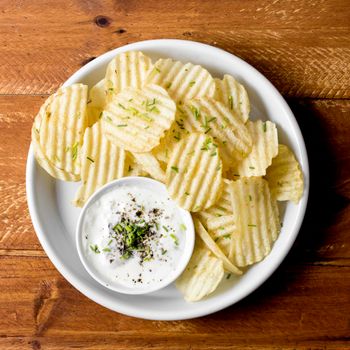 top view potato chips plate with sauce