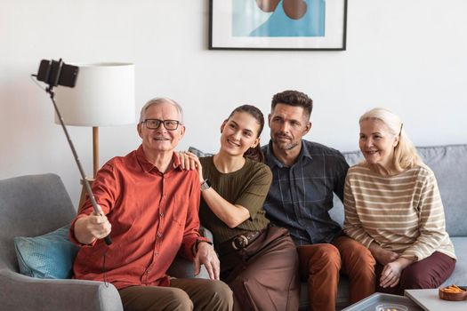 medium shot smiley family taking selfies