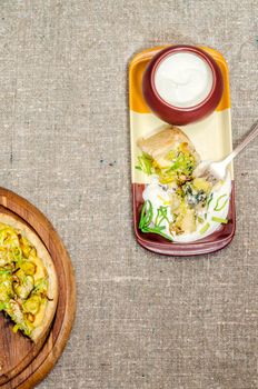 Pie quiche with leeks, cheese and sour cream on rough linen tablecloth From series Homemade bread