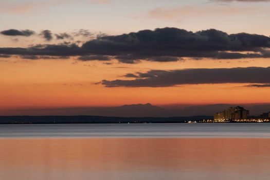 Sunset view of Roses beach in Costa Brava in Catalonia in a long exposure picture