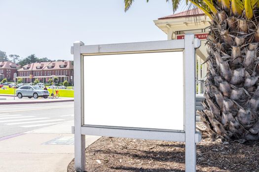 Square white billboard in a modern city.