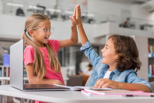 kids high fiving library