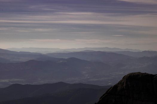 Layers of mountains among the mist view from Montserrat mountain in Catalonia