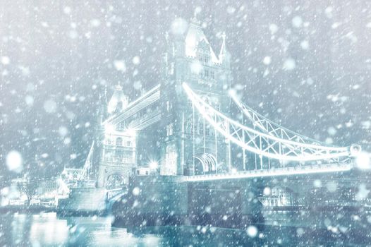 View of Tower Bridge in London by night with snow