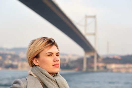 Portrait of a young woman under the Bosporus bridge