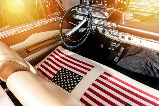 USA flag on seat of a car with sunlight