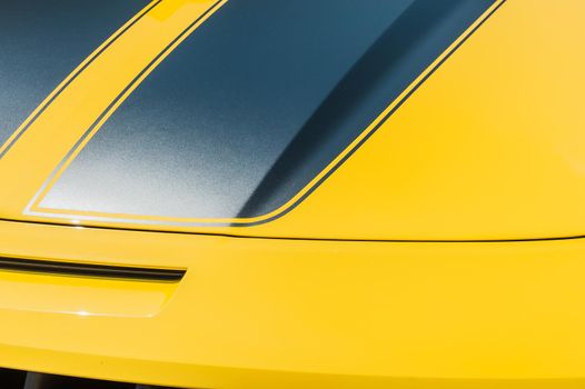 Close up of hood of a yellow sport car: background