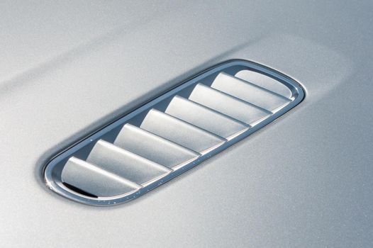 Close up of hood of a grey sport car: background
