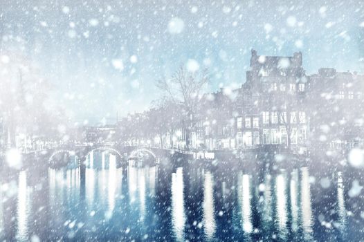 View of Amsterdam by night with snow, Netherlands