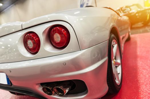 Luxury sport car in a showroom in sunset background