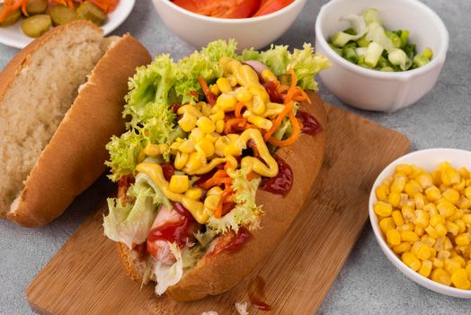 high angle hot dog with salad corn