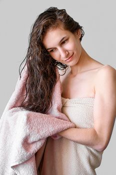 portrait woman drying hair with towel