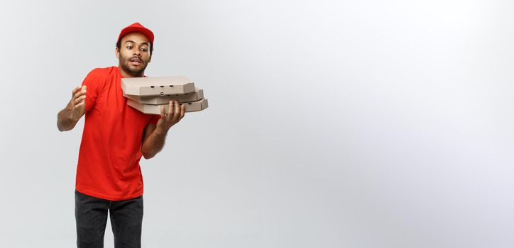 Delivery Concept - Portrait of Handsome African American Pizza delivery man. Isolated on Grey studio Background. Copy Space