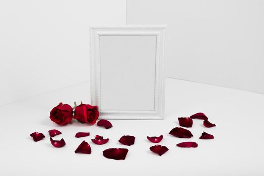 frame with red roses white table