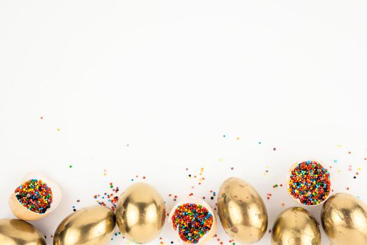 eggshells with sprinkles near golden eggs