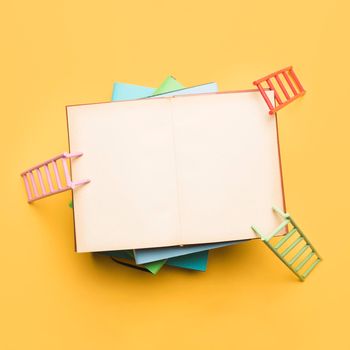 colorful ladders leaning opened notebook