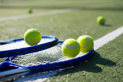 close up tennis rackets balls ground