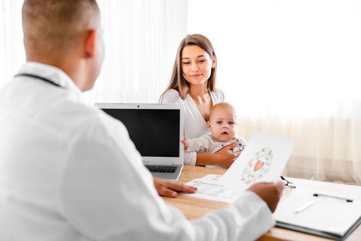 back view doctor talking mother baby