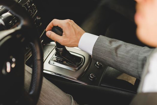 elevated view businessman driving car moving transmission shift gear