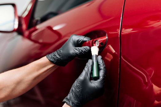 close up person cleaning car exterior