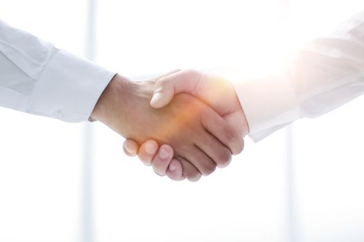 close up.handshake of business people on a light background.concept of partnership