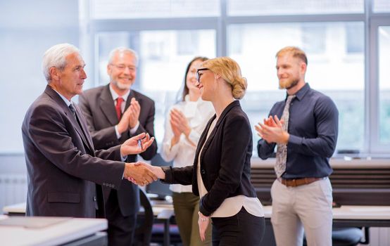 business people shaking hands after successful negotiations office