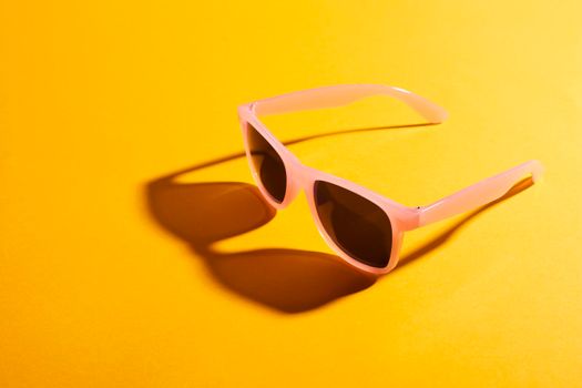 close up colored sunglasses with shadow