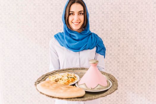 woman holding plate arab food