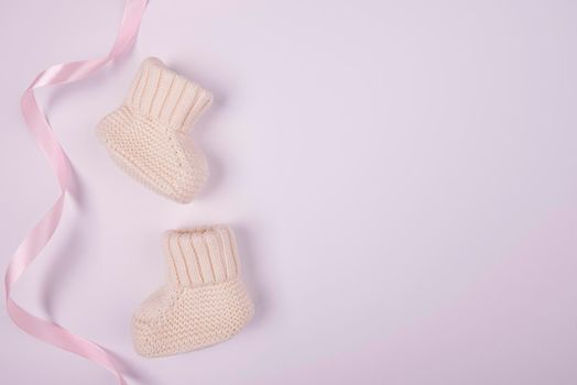 baby socks with pink ribbon flat lay