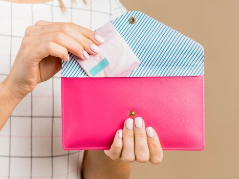 woman holding pad pink wallet