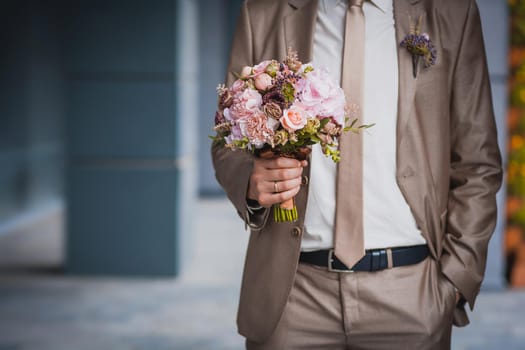 newlywed's hands on the wedding bouquet