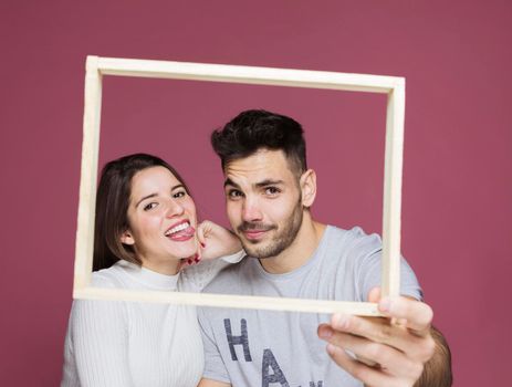 young happy lady with hand shoulder positive guy holding frame