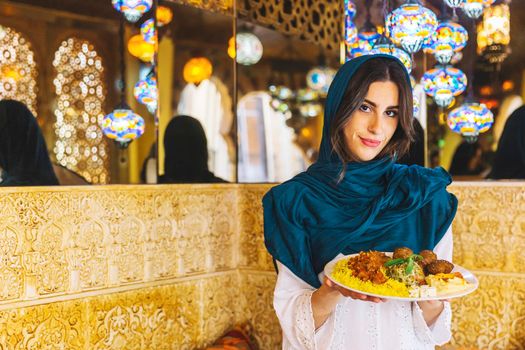 woman holding dish arab food