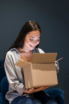 woman looking box after ordering online