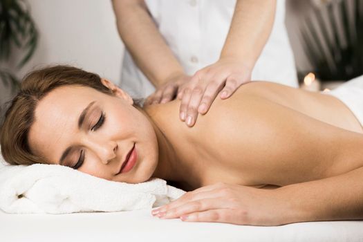 woman receiving massage spa center