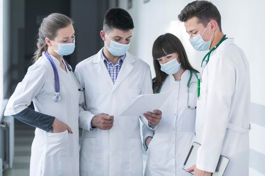 group medics masks reading paper