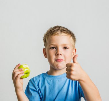 front young boy with green apple