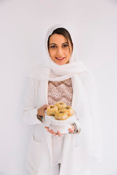 eid concept with woman holding arab pastry